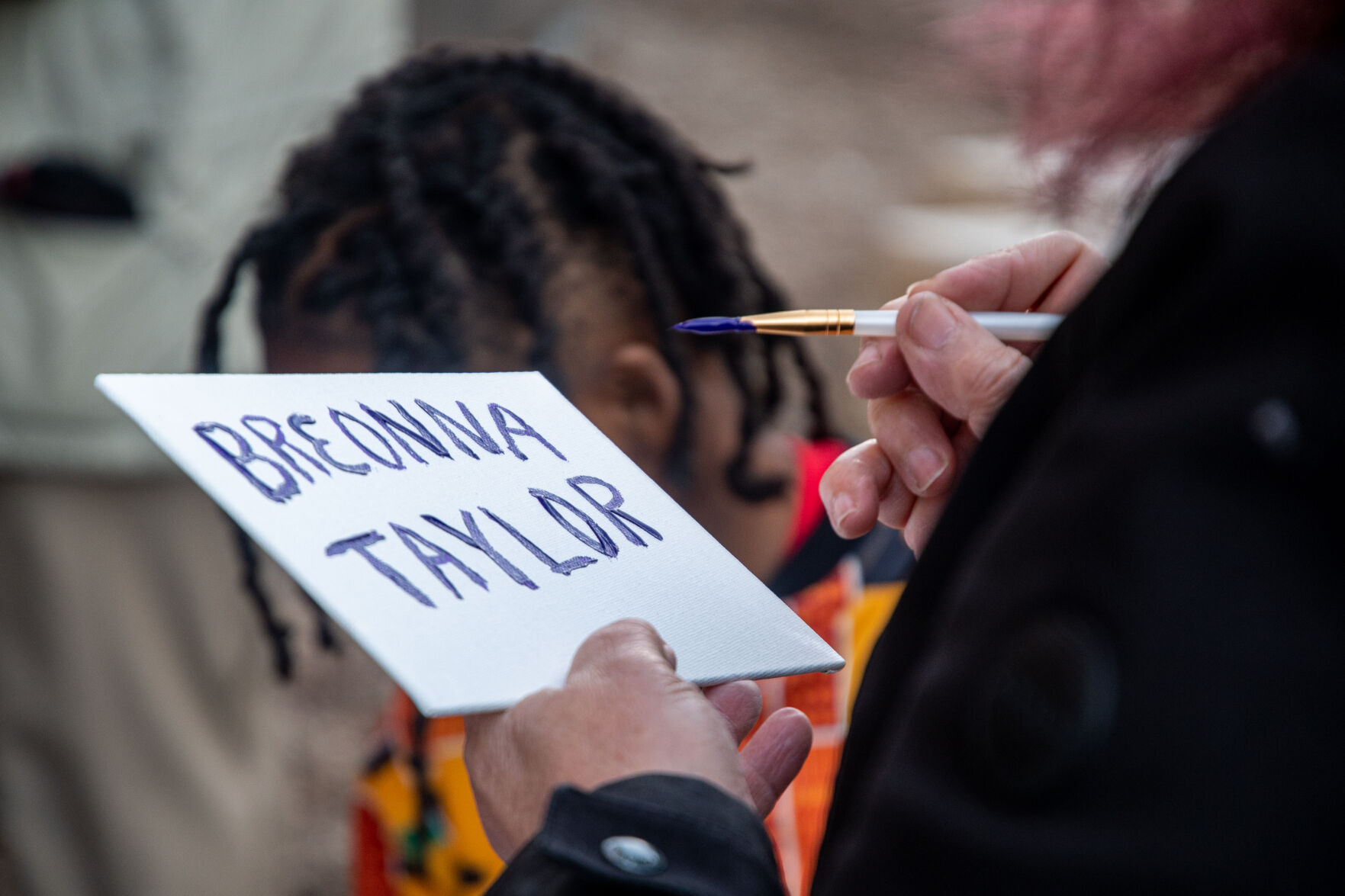 Ellen Freeman paints Breonna Taylor sign at 'Reflect and Respect' event